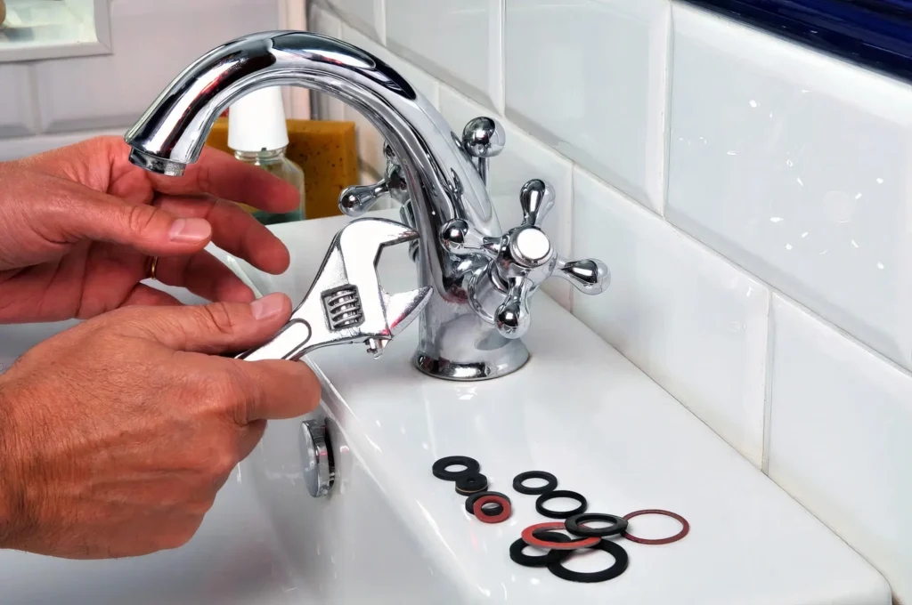 Plumber performing maintenance on a bathroom faucet in Gilroy