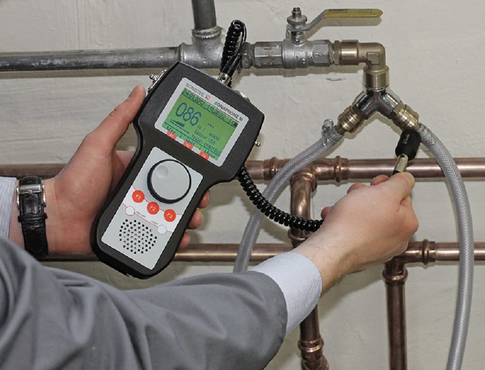 Plumber testing pipes with electronic leak detection equipment in Gilroy