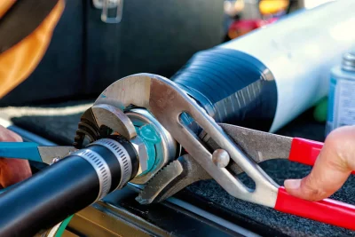 Technician tightening an industrial pipe connection in Gilroy
