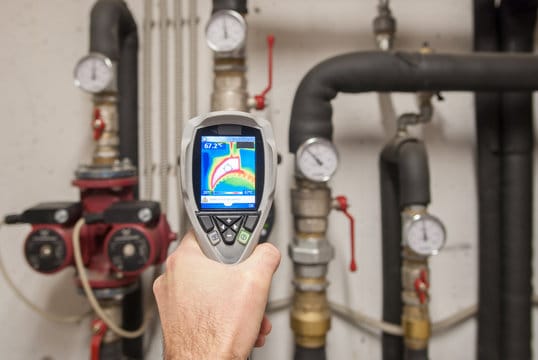 Plumber using a thermal imaging camera to inspect pipes in Gilroy