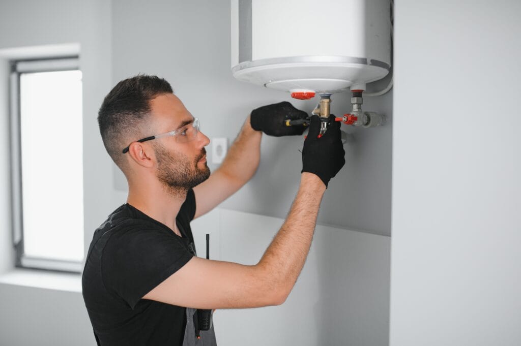 Technician performing water heater maintenance in Gilroy