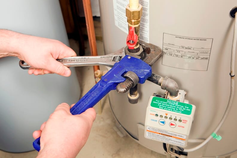 Plumber repairing a water heater valve in Gilroy